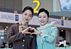 Korean Air and Asiana Airlines cabin crew pose for a photo on Jan. 14 as Asiana began operations at Incheon International Airport Terminal 2. [JOONGANG ILBO]
