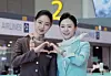 Korean Air and Asiana Airlines cabin crew pose for a photo on Jan. 14 as Asiana began operations at Incheon International Airport Terminal 2. [JOONGANG ILBO]