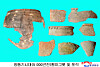Bronze Age spinning-top-shaped vessels and fragments were discovered at a salt production site dating back about 5,000 years in Onchon County, North Korea, as shown in this photo carried by the Korean Central News Agency on April 9. [YONHAP]