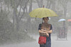 A pedestrian walks under heavy rain in Jongno District, central Seoul, in September 2025. [YONHAP]