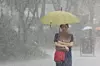 A pedestrian walks under heavy rain in Jongno District, central Seoul, in September 2025. [YONHAP]