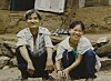 Young-ja, right, and her father pose for a photograph in front of their humble home in a remote mountain in Gangwon in an undated photo. [SCREEN CAPTURE]