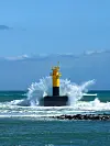 Waves break over a light house in Seogwipo on April 4. [JIM BULLEY]