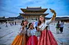 Foreign visitors to Gyeongbok Palace's take selfies in 2025. [NEWS1]