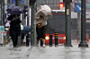 Pedestrians grab onto their umbrellas on a windy and rainy day in Busan on April 9. [NEWS1]