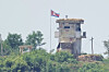 A soldier stands at a North Korean military guard post flying a national flag, seen from Paju, Gyeonggi, on June 26, 2024. [AP/YONHAP]