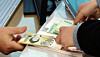 A customer receives new 50,000 won notes at a bank teller inside a Hana Bank branch in Seocho District, southern Seoul, on Feb. 8, 2024. [NEWS1]