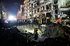 Officers from Israel's Home Front Command search through the rubble of a damaged apartment building after an Iranian missile strike, in Tel Aviv, Israel, on March 1. [AP/YONHAP]
