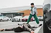 Actor Gang Dong-won as Hyeon-woo leans over a man in ″Wild Sing.″ [LOTTE ENTERTAINMENT]