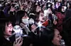 Spectators and fans holding lightening sticks are seen exhilarated while K-pop boyband BTS delivers its performance in the Gwanghwamun area in central Seoul on March 21. [KIM KYOUNG-ROK]