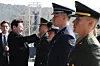 President Lee Jae Myung, left, pins rank insignia on newly commissioned officers during an integrated commissioning ceremony at the Gyeryongdae parade ground in Gyeryong, South Chungcheong, on Feb. 20. [YONHAP]