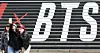 Tourists take a photo in front of a promotional display for BTS’s comeback live performance set up on the steps of the Sejong Center for the Performing Arts in Jongno District, central Seoul, on March 15. [NEWS1]