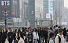 Foreign tourists and residents walk near Gwanghwamun Square in central Seoul on March 15. [YONHAP]