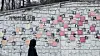 A person views murals on a wall. [WOO JI-WON]