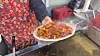 A server holds a plate of vegetable gopchang (intestines). [WOO JI-WON]