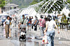 Pedestrian walk through a fountain in central Seoul on May 10. [NEWS1]
