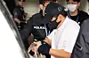 An alleged key drug supplier linked to infamous trafficker Park Wang-yeol boards a police vehicle at Incheon International Airport on May 1. [NEWS1]