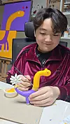 Artist An Dre works on a dinosaur sculpture, which he says is his favorite species. [AN DRE'S FAMILY]