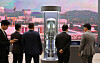 Visitors look at a small modular reactor model set up inside the nuclear power fair at the Bexco convention center in Busan on April 22. [YONHAP]