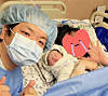 Travel YouTuber Kwak Joon-bin, left, poses for a photograph with his newborn son and his wife in March in a photo uploaded to his Instagram on March 24. [JOONGANG ILBO]