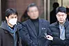 The director of Saekdongwon, center, is seen at Seoul Central District Court in Seocho District, southern Seoul, on Feb. 19 to attend a pretrial detention hearing. Saekdongwon is a residential facility for people with developmental disabilities in Incheon. [YONHAP]
