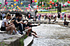 People rest by the water along Cheonggyecheon in central Seoul on May 18, when daytime temperatures climbed to around 30 degrees Celsius (86 degrees Fahrenheit) across much of the country. [YONHAP]