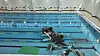 A car lies overturned and submerged in a swimming pool after crashing through a glass wall at the Hanam sports center in Miryang, South Gyeongsang, on May 16. [GYEONGSANGNAM-DO FIRE DEPARTMENT]