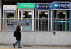 A person walks past ATMs of South Korea's major banks in Seoul, in this file photo taken Dec. 21, 2025. [YONHAP]