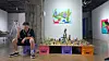 Artist An Dre poses alongside his dinosaur sculptures. [AN DRE'S FAMILY]