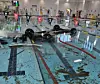 A car lies overturned and submerged in a swimming pool after crashing through a glass wall at Hanam Sports Center in Miryang, South Gyeongsang, on May 16. [YONHAP]