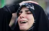 A woman reacts as people gather at the Enghelab Square, after Iran's Supreme Leader Ayatollah Ali Khamenei was killed in Israeli and U.S. strikes on Saturday, in Tehran, Iran, on March 1. [REUTERS]
