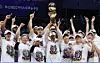 Busan KCC Egis head coach Lee Sang-min, center, celebrates with players while lifting the championship trophy after KCC defeated the Goyang Sono Skygunners in Game 5 of the 2025-26 KBL finals at Goyang Sono Arena in Goyang, Gyeonggi, on May 13. [NEWS1]