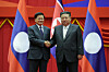 In this photo released by the Korean Central News Agency on Oct. 8, 2025, North Korean leader Kim Jong-un, right, shakes hands with Lao President Thongloun Sisoulith in Pyongyang the previous day during the Lao leader's visit to the North to attend celebrations marking the 80th anniversary of the founding of the North's ruling Workers' Party. [YONHAP]
