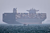 A container ship sits at anchor as a small motorboat passes in the foreground in the Strait of Hormuz off Bandar Abbas, Iran, on May 2. [AP/YONHAP]