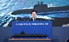 President Lee Jae Myung watches a video during the first meeting of the Future Defense Strategy Committee held in Jinhae, South Gyeongsang, on May 26. [JOINT PRESS CORPS]