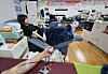 Students donate blood as part of the blood donation relay event held at Dong-eui University in Busan on April 2. [YONHAP]