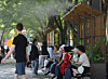 People take shelter under an awning that sprays cooling mist at Seoul Forest in Seongdong District, eastern Seoul, on May 14. [YONHAP]