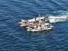 A helicopter from the Yeosu Aviation Unit under the West Sea Regional Coast Guard operates surveillance equipment to film an illegal fishing vessel on Aug. 9, 2024. [NEWS1]