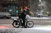 A person on a delivery bike rides through the snow in New York City on Feb. 22. [AFP/YONHAP]