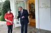 U.S. President Donald Trump tips Doordash delivery worker Sharon Simmons after she delivered McDonald's outside of the Oval Office at the White House in Washington on April 13. [AFP/YONHAP]