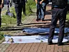 Investigators inspect on May 5 the site where a fatal stabbing happened in Gwangju. [NEWS1]