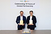 Jonathan Song, CEO of the Global Business Division at CJ Logistics, right, and Emun Zabihi, CEO of iHerb, pose for a commemorative photo after exchanging plaques of appreciation at an event to mark the 10th anniversary of their partnership at iHerb’s headquarters in Irvine, California, on May 7. [CJ LOGISTICS]