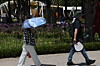 Pedestrians walk with umbrellas to protect themselves from sunlight in eastern Seoul on May 14. [YONHAP]