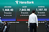 A man walks by a display of the Kospi and Kosdaq benchmarks at the main trading room of Hana Bank in Jung District, central Seoul, on May 11. [NEWS1]