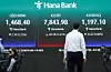 A man walks by a display of the Kospi and Kosdaq benchmarks at the main trading room of Hana Bank in Jung District, central Seoul, on May 11. [NEWS1]