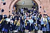 International students throw their graduation caps at their graduation ceremony at Dong-A University, Busan. Dong-A University is one of the five univeristies that were selected as participating universities of the Korea Institute for Advancement of Technology's employment support initiative for international students. [YONHAP]