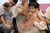 Babies participating in the “Cutie Baby” category take the stage alongside their parents during the Baby Festival held at Bexco in Haeundae District on Sept. 5, 2025. [NEWS1]
