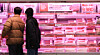 Customers look at products at the meat section of a supermarket in Seoul on Feb. 3. [YONHAP]
