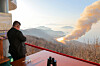 North Korean leader Kim Jong-un oversees a ground test of a high-thrust solid-fuel missile engine using a composite carbon fiber material in a photo shared on March 29. [NEWS1]