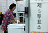 An eligible voter casts her vote for the 2026 local elections at a polling station in Dongjak District, southern Seoul, on June 3. [NEWS1]